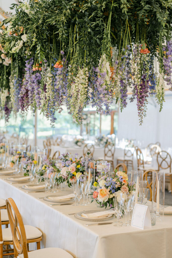 Gorgeous florals on and above table at reception for Castle Hill Inn wedding.