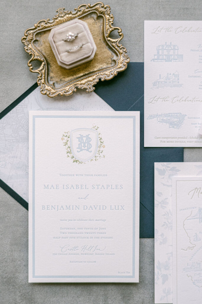 Custom crest on light blue letterpress oversized invitation
