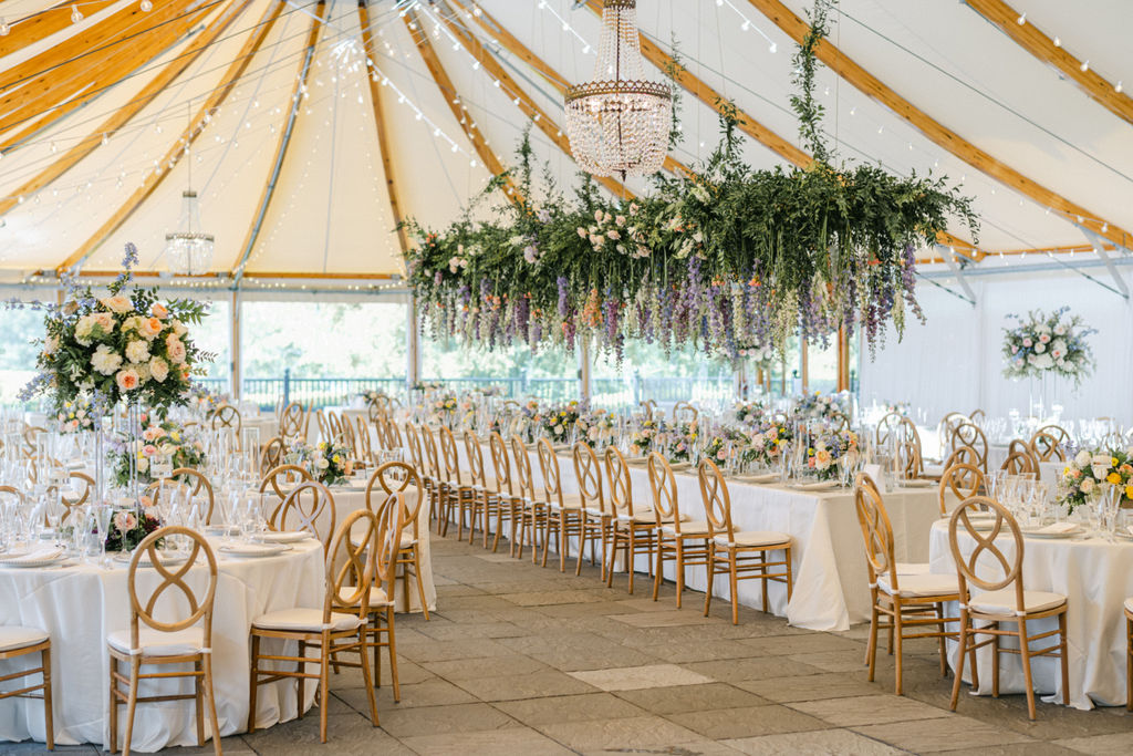 Reception Tent showing set up at Castle Hill Inn. Features interior of tent, lights, florals and seating.